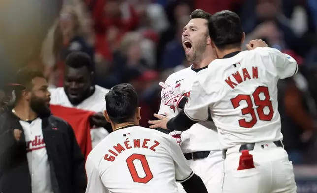 Cleveland Guardians' David Fry, second from right, celebrates with teammates after hitting a game-winning two-run home run against the New York Yankees during the 10th inning in Game 3 of the baseball AL Championship Series Thursday, Oct. 17, 2024, in Cleveland. The Guardians won 7-5. (AP Photo/Godofredo Vásquez )