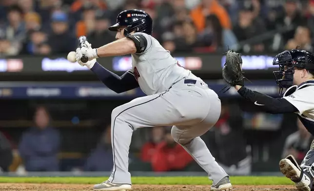 Cleveland Guardians' David Fry bunts in the ninth inning during Game 4 of a baseball American League Division Series against the Detroit Tigers, Thursday, Oct. 10, 2024, in Detroit. (AP Photo/Carlos Osorio)