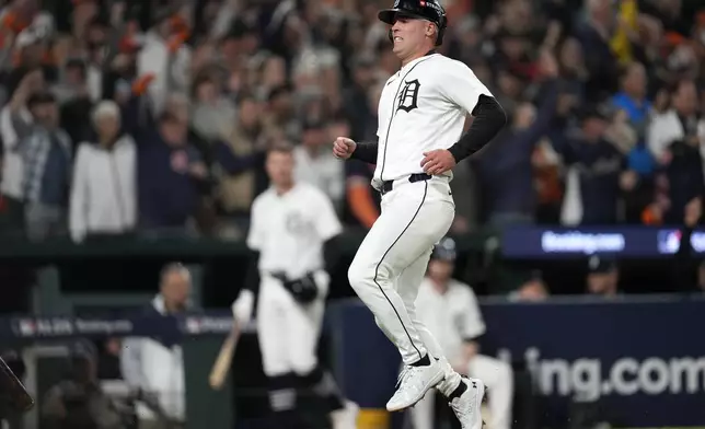 Detroit Tigers' Kerry Carpenter reacts after scoring in the sixth inning during Game 4 of a baseball American League Division Series against the Cleveland Guardians, Thursday, Oct. 10, 2024, in Detroit. (AP Photo/Paul Sancya)