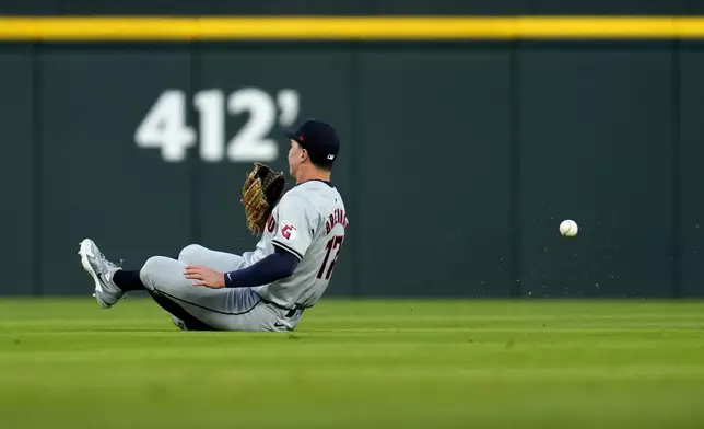 Cleveland Guardians right fielder Will Brennan makes a sliding attempt at a double by Detroit Tigers' Parker Meadows in the first inning during Game 4 of a baseball American League Division Series, Thursday, Oct. 10, 2024, in Detroit. (AP Photo/Paul Sancya)