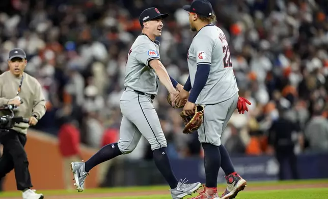 Cleveland Guardians' Will Brennan, left, and Josh Naylor celebrate at the end of Game 4 of a baseball American League Division Series against the Detroit Tigers, Thursday, Oct. 10, 2024, in Detroit. The Guardians won 5-4. (AP Photo/Carlos Osorio)