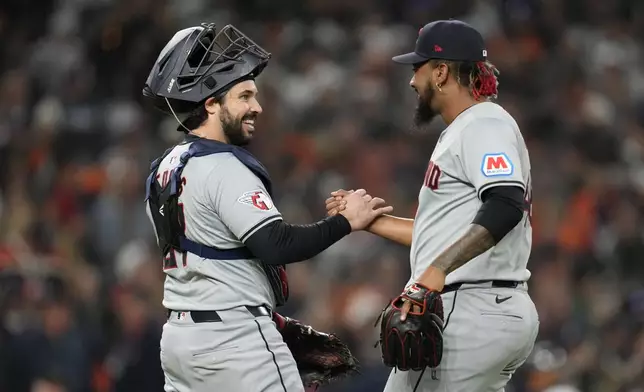 Cleveland Guardians catcher Austin Hedges, left, celebrates with pitcher Emmanuel Clase at the end of Game 4 of a baseball American League Division Series against the Detroit Tigers, Thursday, Oct. 10, 2024, in Detroit. The Guardians won 5-4. (AP Photo/Paul Sancya)