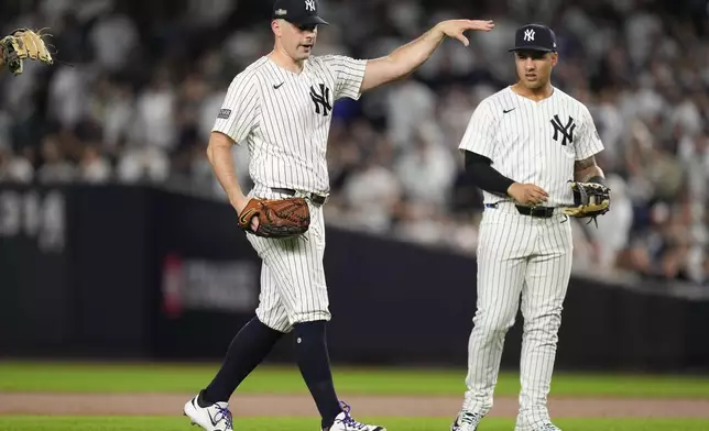 New York Yankees pitcher Carlos Rodón motions to the dugout after knocking down a line drive ball during the third inning of Game 2 of the American League baseball playoff series against the Kansas City Royals, Monday, Oct. 7, 2024, in New York. (AP Photo/Seth Wenig)