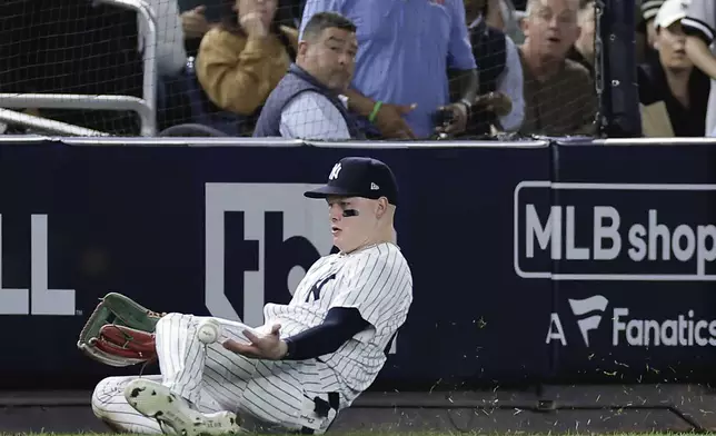 New York Yankees outfielder Alex Verdugo (24) comes up with the catch on a fly ball hit by Kansas City Royals' Michael Massey to end the fourth inning during Game 1 of the American League baseball division series, Saturday, Oct. 5, 2024, in New York. (AP Photo/Adam Hunger)