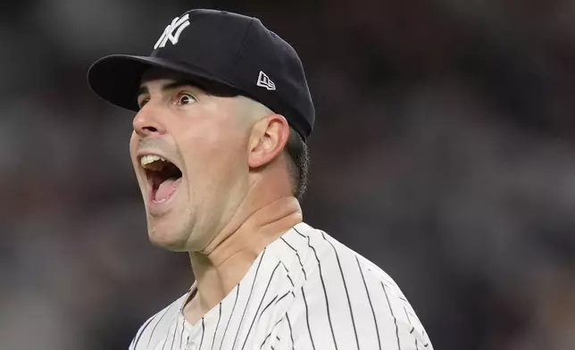 New York Yankees pitcher Carlos Rodón (55) reacts after striking out the batter during the first inning of Game 2 of the American League baseball playoff series against the Kansas City Royals, Monday, Oct. 7, 2024, in New York. (AP Photo/Seth Wenig)