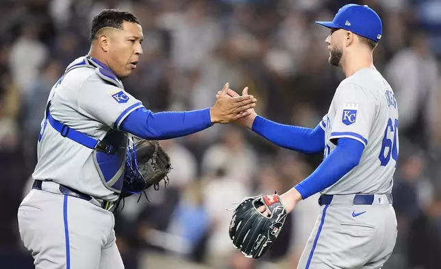 Kansas City Royals pitcher Lucas Erceg (60) and catcher Salvador Perez (13) celebrate after beating the New York Yankees in Game 2 of the American League baseball playoff series, Monday, Oct. 7, 2024, in New York. (AP Photo/Frank Franklin II)