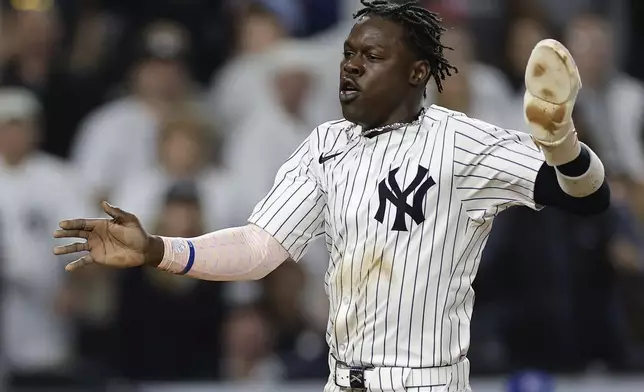 New York Yankees' Jazz Chisholm Jr. reacts as he scores against the Kansas City Royals during the seventh inning of Game 1 of the American League baseball division series, Saturday, Oct. 5, 2024, in New York. (AP Photo/Adam Hunger)