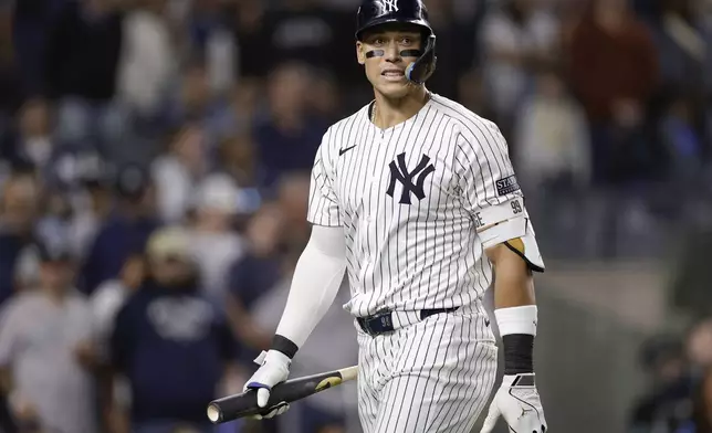 New York Yankees outfielder Aaron Judge (99) reacts after striking out against the Kansas City Royals during the sixth inning of Game 1 of the American League baseball division series, Saturday, Oct. 5, 2024, in New York. (AP Photo/Adam Hunger)