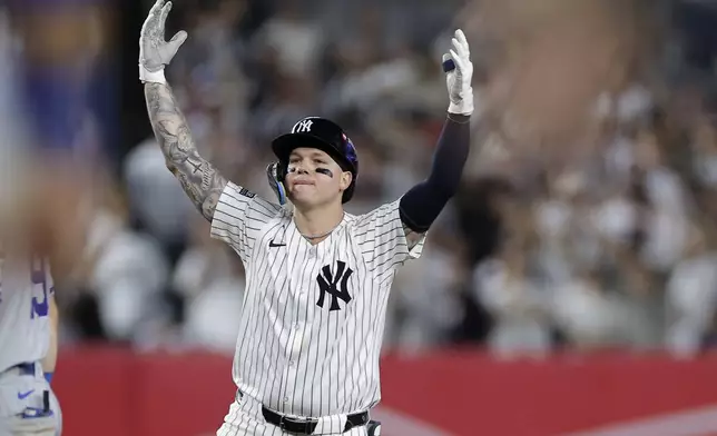 New York Yankees' Alex Verdugo reacts after driving in a run on a double against the Kansas City Royals during the seventh inning of Game 1 of the American League baseball division series, Saturday, Oct. 5, 2024, in New York. (AP Photo/Adam Hunger)