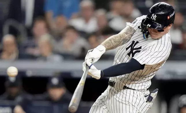 New York Yankees' Alex Verdugo (24) connects for a double to drive in a run against the Kansas City Royals during the seventh inning of Game 1 of the American League baseball division series, Saturday, Oct. 5, 2024, in New York. (AP Photo/Frank Franklin II)