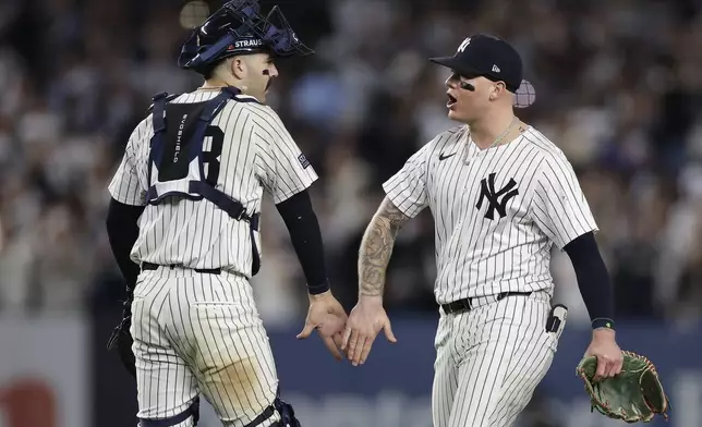 New York Yankees catcher Austin Wells (28) and outfielder Alex Verdugo celebrate after defeating the Kansas City Royals in Game 1 of the American League baseball division series, Saturday, Oct. 5, 2024, in New York. (AP Photo/Adam Hunger)