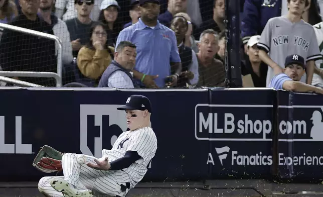 New York Yankees outfielder Alex Verdugo (24) comes up with the catch on a fly ball hit by Kansas City Royals' Michael Massey to end the fourth inning during Game 1 of the American League baseball division series, Saturday, Oct. 5, 2024, in New York. (AP Photo/Adam Hunger)