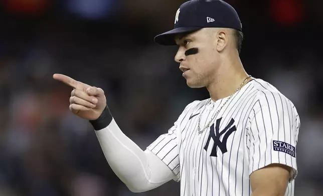 New York Yankees outfielder Aaron Judge motions as he walks off the field after the Yankees defeated the Kansas City Royals in Game 1 of the American League baseball division series, Saturday, Oct. 5, 2024, in New York. (AP Photo/Adam Hunger)