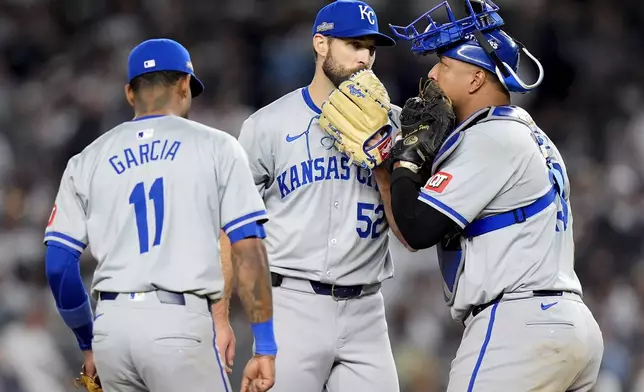 From left, Kansas City Royals third baseman Maikel Garcia (11), pitcher Michael Wacha (52) and catcher Salvador Perez (13) talk on the mound during the fourth inning of Game 1 of the American League baseball division series, Saturday, Oct. 5, 2024, in New York. (AP Photo/Frank Franklin II)