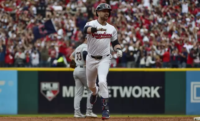 Cleveland Guardians' Lane Thomas celebrates as he runs the bases after hitting grand slam in the fifth inning during Game 5 of baseball's American League Division Series against the Detroit Tigers, Saturday, Oct. 12, 2024, in Cleveland. (AP Photo/Phil Long)