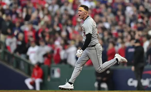 Detroit Tigers' Kerry Carpenter celebrates as he runs the bases with a three-run home run in the ninth inning during Game 2 of baseball's AL Division Series against the Cleveland Guardians, Monday, Oct. 7, 2024, in Cleveland. (AP Photo/David Dermer)