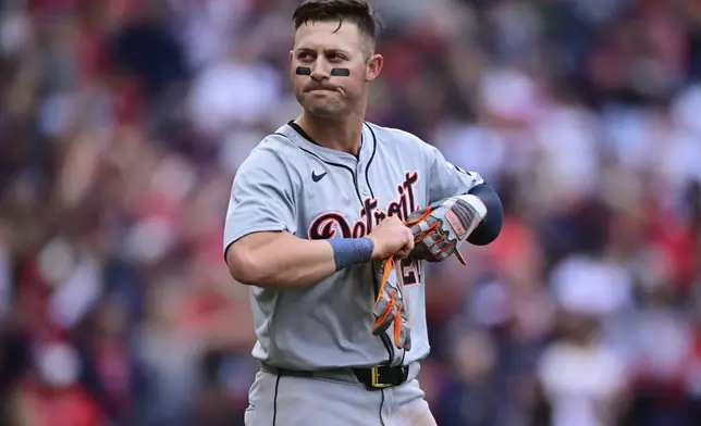 Detroit Tigers' Spencer Torkelson takes off his batting gloves after striking out in the seventh inning during Game 5 of baseball's American League Division Series against the Cleveland Guardians, Saturday, Oct. 12, 2024, in Cleveland. (AP Photo/David Dermer)