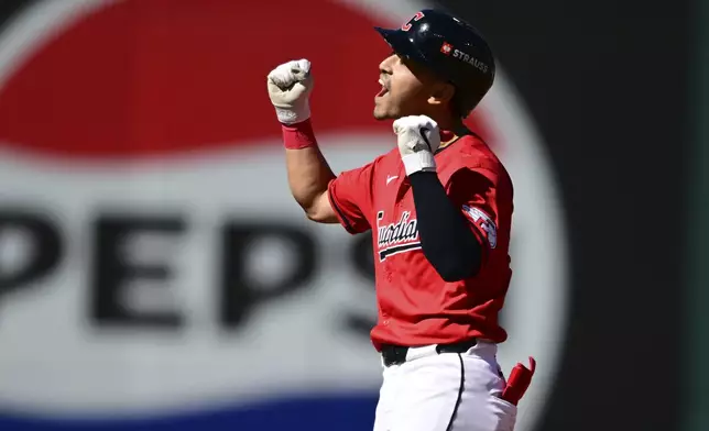 Cleveland Guardians left fielder Steven Kwan celebrates his double at second base in the first inning during Game 1 of the baseball's American League Division Series against the Detroit Tigers, Saturday, Oct. 5, 2024, in Cleveland. (AP Photo/David Dermer)