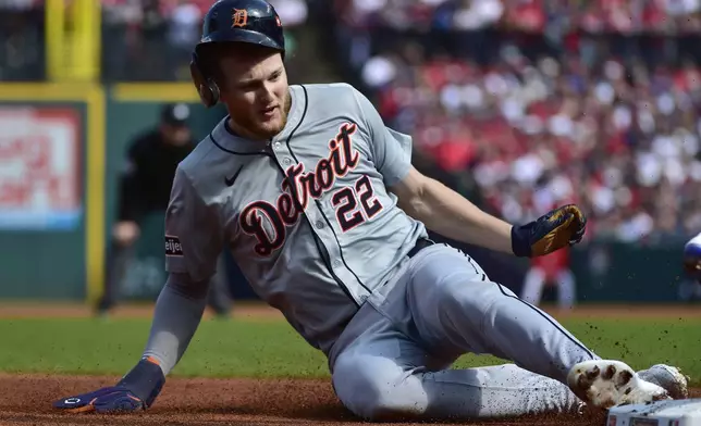 Detroit Tigers' Parker Meadows (22) steals third base during the second inning in Game 5 of baseball's American League Division Series against the Cleveland Guardians, Saturday, Oct. 12, 2024, in Cleveland. (AP Photo/Phil Long)