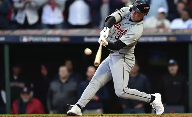 Detroit Tigers' Kerry Carpenter hits a three-rum home run in the ninth inning during Game 2 of baseball's AL Division Series against the Cleveland Guardians, Monday, Oct. 7, 2024, in Cleveland. (AP Photo/David Dermer)