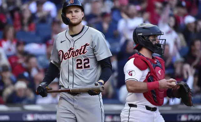 Detroit Tigers' Parker Meadows (22) walks back to the dugout after striking out in the fourth inning during Game 2 of baseball's AL Division Series against the Cleveland Guardians, Monday, Oct. 7, 2024, in Cleveland. Guardians catcher Austin Hedges is at right. (AP Photo/Phil Long)