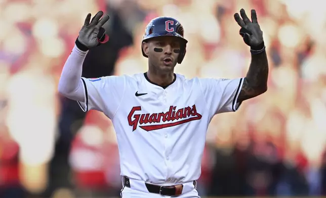 Cleveland Guardians' Brayan Rocchio gestures from second base after hitting a double in the sixth inning during Game 2 of baseball's AL Division Series against the Detroit Tigers, Monday, Oct. 7, 2024, in Cleveland. (AP Photo/David Dermer)