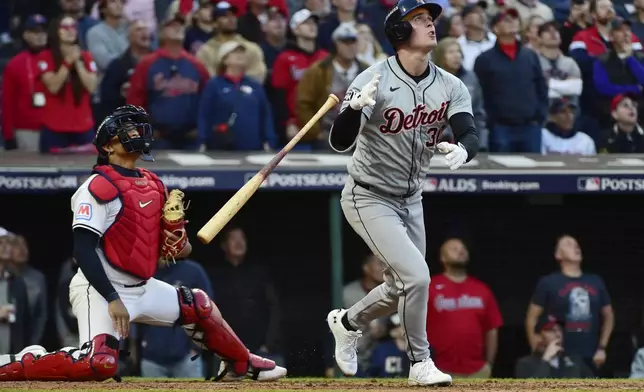 Cleveland Guardians catcher Bo Naylor, left, and Detroit Tigers' Kerry Carpenter, right, watch Carpenter's three-run home run in the ninth inning during Game 2 of baseball's AL Division Series, Monday, Oct. 7, 2024, in Cleveland. (AP Photo/Phil Long)