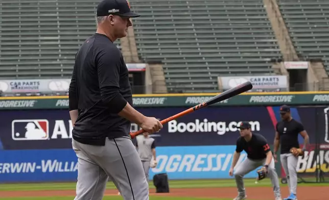 Detroit Tigers manager A.J. Hinch walks to the outfield during a baseball workout in Cleveland, Friday, Oct. 4, 2024, in preparation for the American League Division Series against the Cleveland Guardians. (AP Photo/Sue Ogrocki)