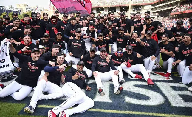 The Cleveland Guardians celebrate after the Guardians defeated the Tigers in Game 5 of baseball's American League Division Series, Saturday, Oct. 12, 2024, in Cleveland. (AP Photo/David Dermer)