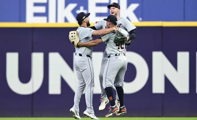 Detroit Tigers' outfielders Riley Greene, left, Wendell Perez, center, and Parker Meadows, right, celebrate after the Tigers defeated the Guardians in Game 2 of baseball's AL Division Series, Monday, Oct. 7, 2024, in Cleveland. (AP Photo/David Dermer)