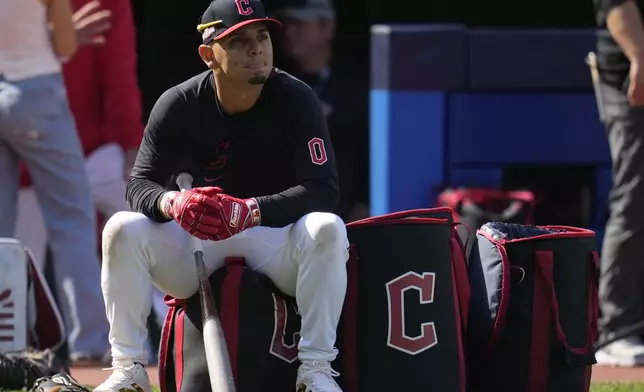 Cleveland Guardians' Andres Gimenez waits for his turn in the batting cage during a baseball workout in Cleveland, Friday, Oct. 4, 2024, in preparation for the American League Division Series against the Detroit Tigers. (AP Photo/Sue Ogrocki)