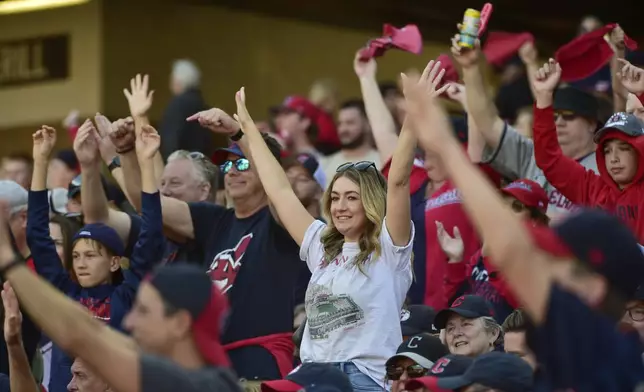 Fans cheer in the fifth inning during Game 1 of baseball's AL Division Series between the Detroit Tigers and the Cleveland Guardians, Saturday, Oct. 5, 2024, in Cleveland. (AP Photo/Phil Long)