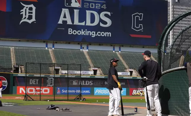 Cleveland Guardians' Jose Ramirez, left, and David Fry, right, talk near the batting cage during a baseball workout in Cleveland, Friday, Oct. 4, 2024, in preparation for the American League Division Series against the Detroit Tigers. (AP Photo/Sue Ogrocki)