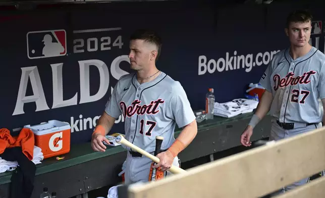 Detroit Tigers' Jace Jung (17) and Trey Sweeney (27) walk out of the dugout into the clubhouse after the Cleveland Guardians defeated them in Game 5 of baseball's American League Division Series, Saturday, Oct. 12, 2024, in Cleveland. (AP Photo/David Dermer)