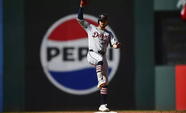 Detroit Tigers' Zach McKinstry celebrates a hitting a double at second base during the second inning of Game 1 of baseball's AL Division Series against the Cleveland Guardians, Saturday, Oct. 5, 2024, in Cleveland. (AP Photo/David Dermer)