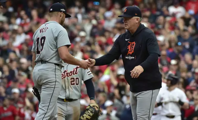 Detroit Tigers manager A.J. Hinch, right, takes relief pitcher Will Vest (19) out of the game in the seventh inning during Game 5 of baseball's American League Division Series against the Detroit Tigers, Saturday, Oct. 12, 2024, in Cleveland. (AP Photo/Phil Long)