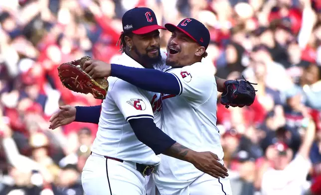 Cleveland Guardians' Emmanuel Clase, left, and Josh Naylor, right, celebrate after the Guardians defeated the Detroit Tigers in Game 5 of baseball's American League Division Series, Saturday, Oct. 12, 2024, in Cleveland. (AP Photo/Phil Long)