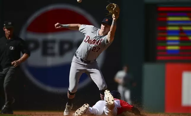 Cleveland Guardians' Andres Gimenez, right, steals second base as Detroit Tigers shortstop Trey Sweeney takes the throw in the third inning during Game 1 of baseball's AL Division Series, Saturday, Oct. 5, 2024, in Cleveland. (AP Photo/David Dermer)