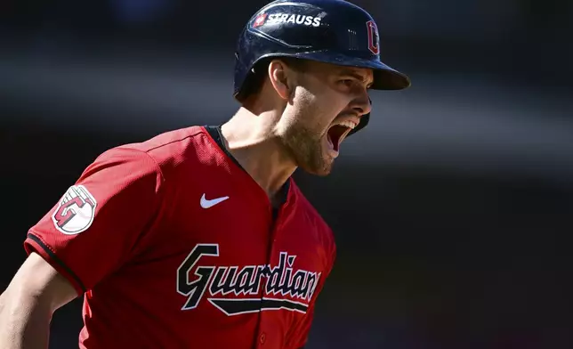 Cleveland Guardians' Lane Thomas shouts as he runs the bases after hitting a home run in the first inning during Game 1 of baseball's AL Division Series against the Detroit Tigers, Saturday, Oct. 5, 2024, in Cleveland. (AP Photo/David Dermer)