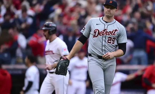 Detroit Tigers starting pitcher Tarik Skubal (29) reacts as Cleveland Guardians' David Fry rounds third base behind him on a grand slam hit by Lane Thomas in the fifth inning during Game 5 of baseball's American League Division Series, Saturday, Oct. 12, 2024, in Cleveland. (AP Photo/David Dermer)