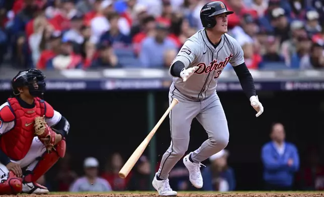 Detroit Tigers' Kerry Carpenter, right, and Cleveland Guardians catcher Bo Naylor, left, watch Carpenter's single in the fifth inning during Game 5 of baseball's American League Division Series, Saturday, Oct. 12, 2024, in Cleveland. (AP Photo/David Dermer)