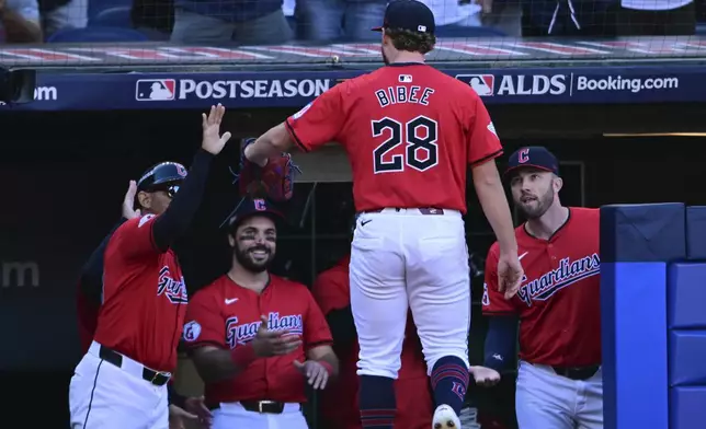 Cleveland Guardians starting pitcher Tanner Bibee is greeted as he returns to the dugout after being taken out of the game in the fifth inning during Game 1 of baseball's AL Division Series against the Detroit Tigers, Saturday, Oct. 5, 2024, in Cleveland. (AP Photo/David Dermer)