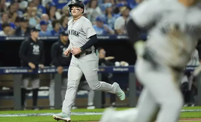 New York Yankees' Alex Verdugo scores during the fifth inning in Game 4 of an American League Division baseball playoff series against the Kansas City Royals Thursday, Oct. 10, 2024, in Kansas City, Mo. (AP Photo/Charlie Riedel)