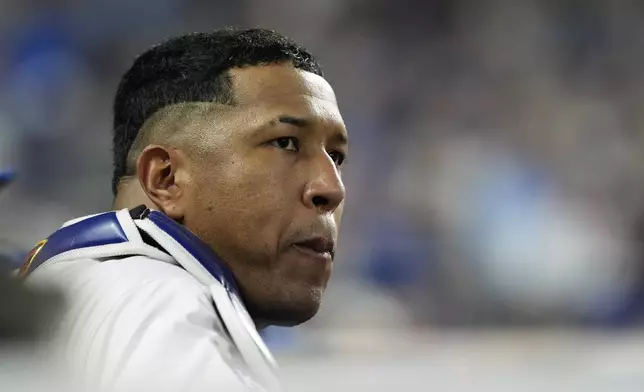 Kansas City Royals' Salvador Perez watches from the dugout during the fifth inning in Game 4 of an American League Division baseball playoff series against the New York Yankees Thursday, Oct. 10, 2024, in Kansas City, Mo. (AP Photo/Charlie Riedel)