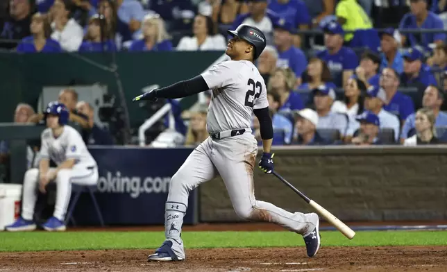 New York Yankees' Juan Soto follows through on a sacrifice fly to score Anthony Volpe during the fifth inning in Game 3 of an American League Division baseball playoff series against the Kansas City Royals Wednesday, Oct. 9, 2024, in Kansas City, Mo. (AP Photo/Colin Braley)