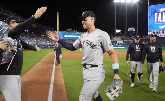 New York Yankees' Aaron Judge celebrates a 3-1 victory over the Kansas City Royals in Game 4 of an American League Division baseball playoff series Thursday, Oct. 10, 2024, in Kansas City, Mo. (AP Photo/Charlie Riedel)