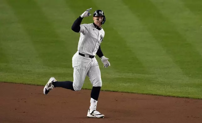 New York Yankees' Aaron Judge celebrates after hitting a two-run home run against the Cleveland Guardians during the seventh inning in Game 2 of the baseball AL Championship Series Tuesday, Oct. 15, 2024, in New York. (AP Photo/Seth Wenig)