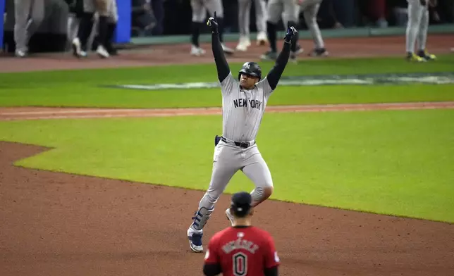 New York Yankees' Juan Soto celebrates after hitting a three-run home run against the Cleveland Guardians during the 10th inning in Game 5 of the baseball AL Championship Series Saturday, Oct. 19, 2024, in Cleveland. (AP Photo/Jeff Roberson)