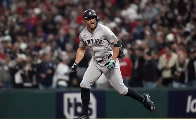 New York Yankees' Giancarlo Stanton celebrates after hitting a home run against the Cleveland Guardians during the eighth inning in Game 3 of the baseball AL Championship Series Thursday, Oct. 17, 2024, in Cleveland.(AP Photo/Jeff Roberson)