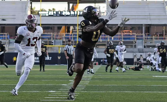 Vanderbilt wide receiver Junior Sherrill (0) makes a catch for a touchdown ahead of Alabama defensive back Malachi Moore (13) during the second half of an NCAA college football game Saturday, Oct. 5, 2024, in Nashville, Tenn. (AP Photo/George Walker IV)